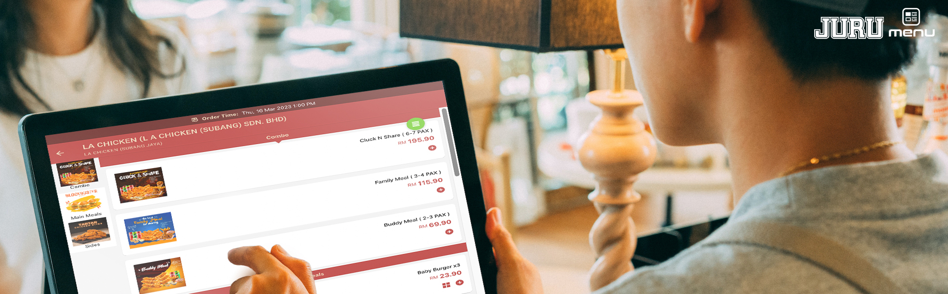 Diner browsing an interactive JuruMenu ordering screen at the table